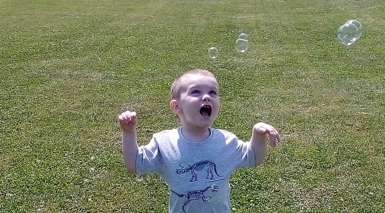Logan blows bubbles