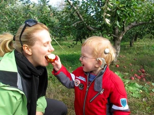 Andrej feeds his mom an apple