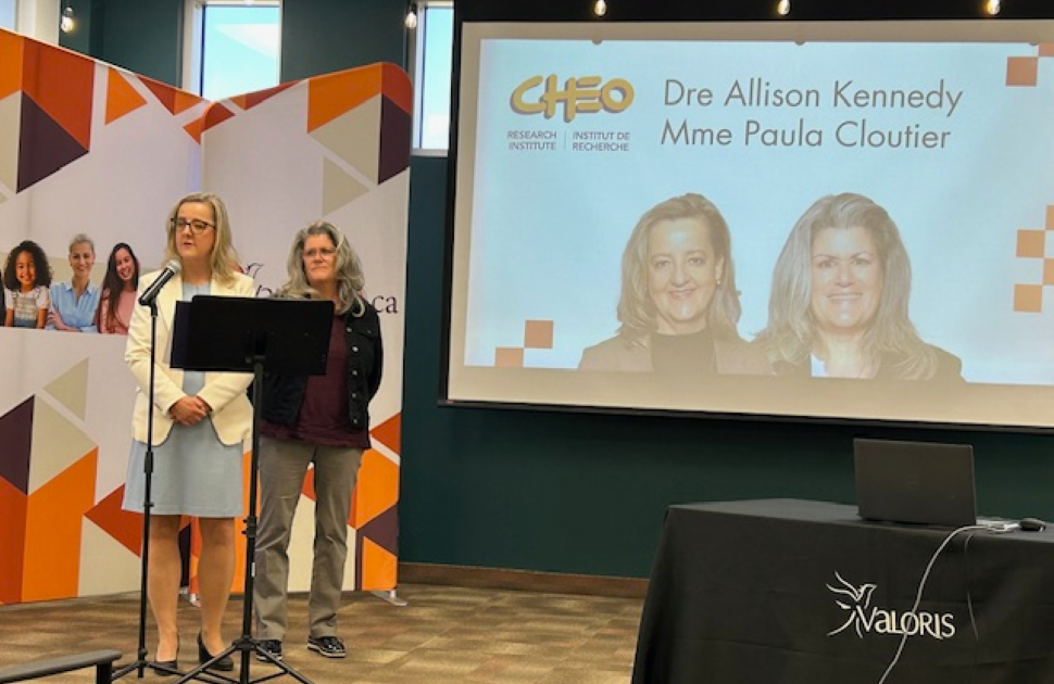 female doctor and researcher stand and speak at news conference