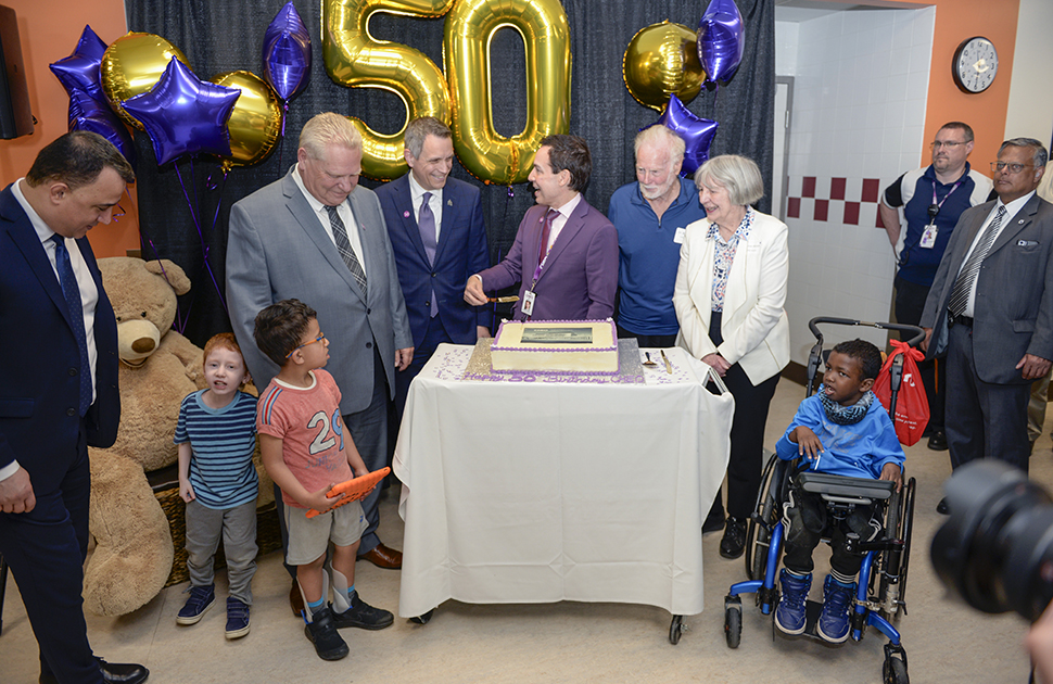 children premier ministers alex munter cheo alumni cut CHEO birthday cake