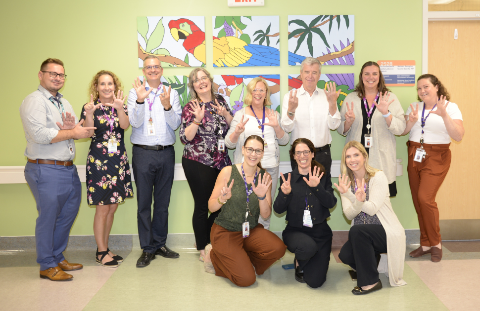 CHEO staff pose holding up fingers for the number 7 for HIMSS7