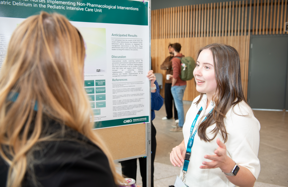 nurse discusses research at conference