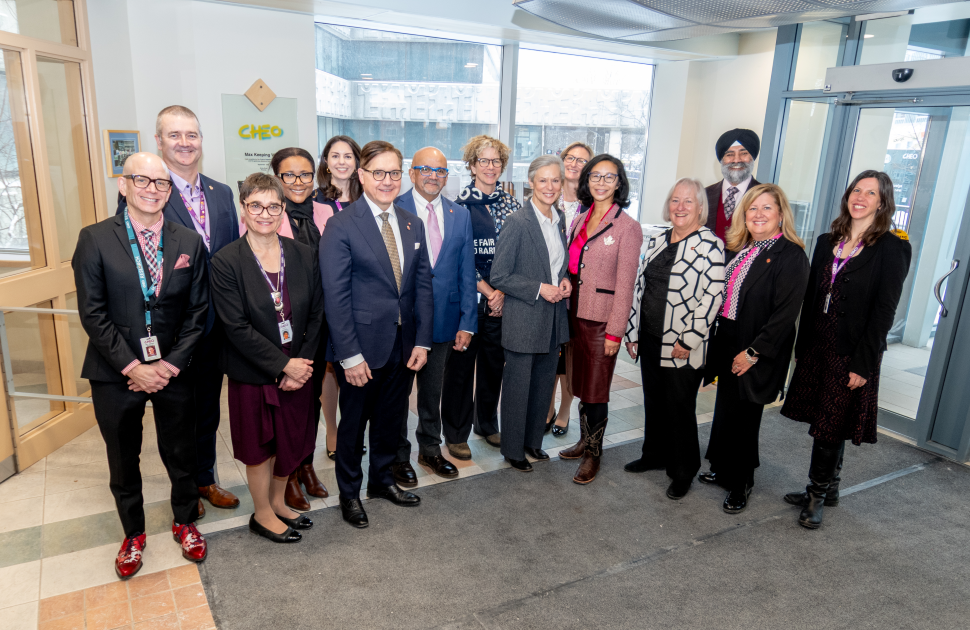 group of canadian senators stands and poses with cheo leaders