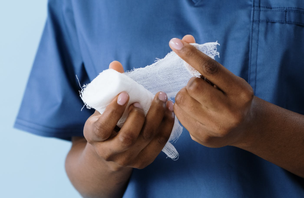 Health care provider holding gauze