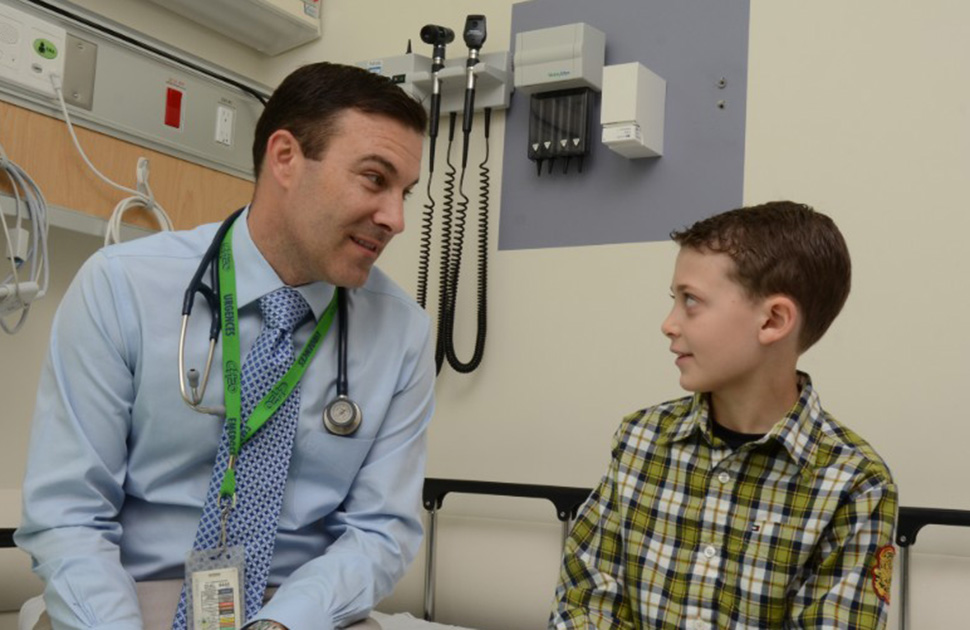 Child and physician smiling at each other