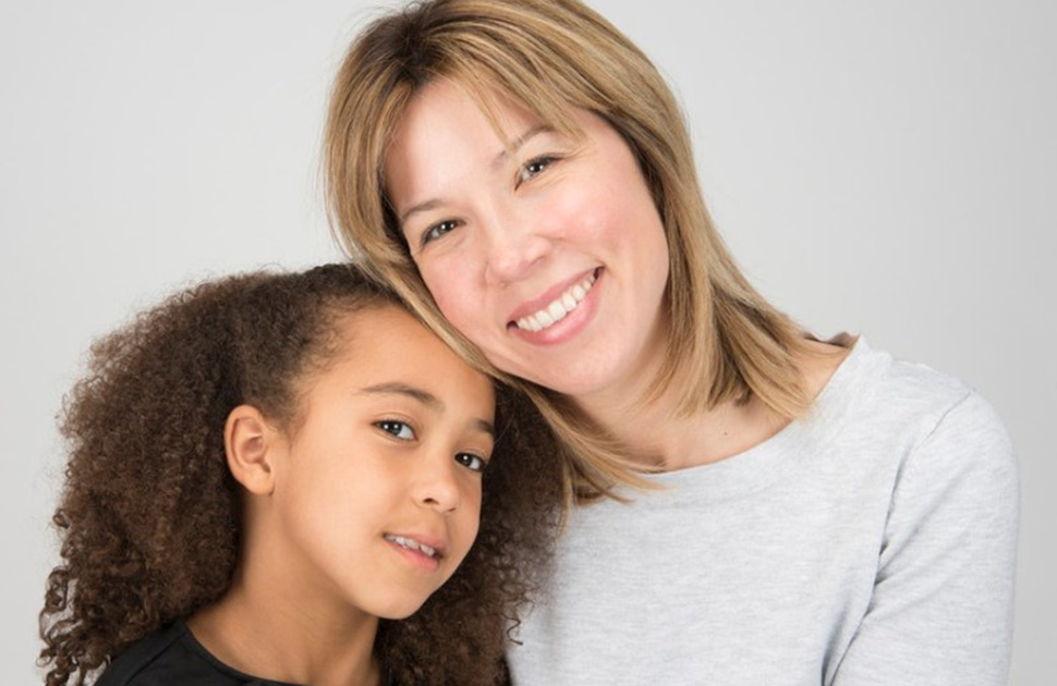 Mother and child smiling at camera