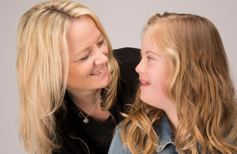 Mother and daughter smiling at each other