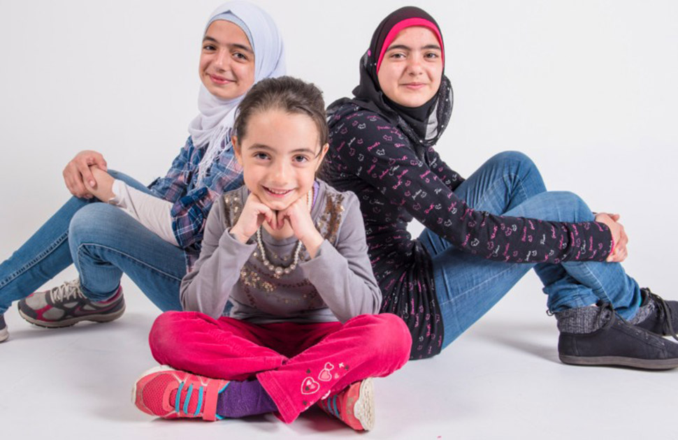 Three sisters smiling at the camera