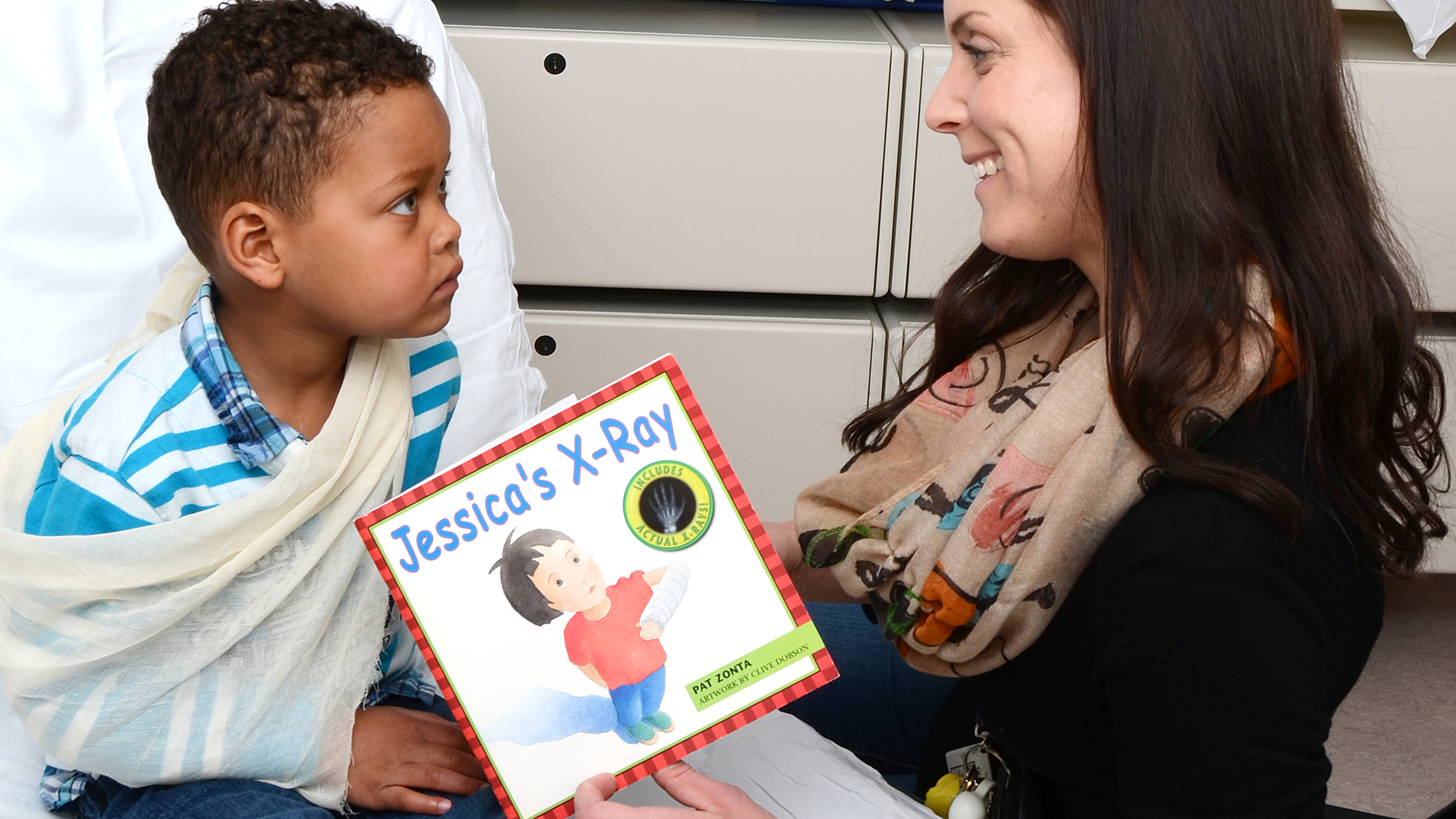 woman reading to young boy